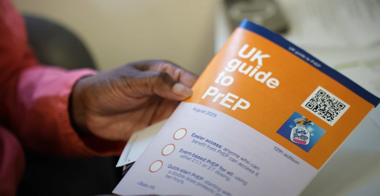 A hand holding a leaflet with the title "UK guide to PrEP"