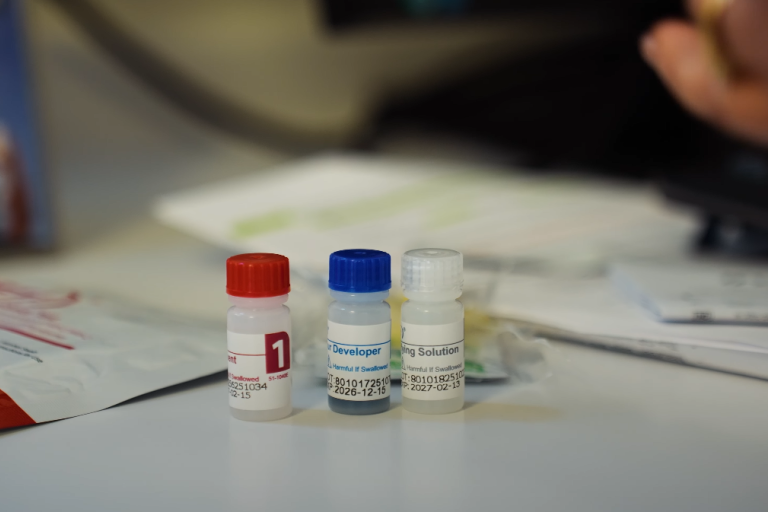 Three vials of PrEP medication sitting on a table in on the GP desk.